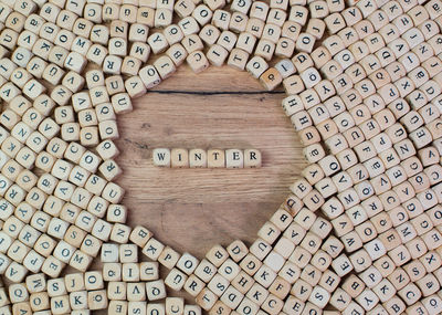 High angle view of alphabets on blocks at wooden table