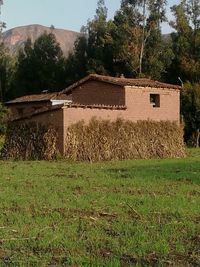 Built structure on field against sky