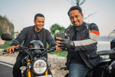 Portrait of man riding motorcycle on road