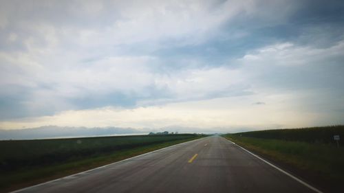 View of highway against cloudy sky