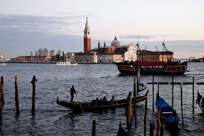 Boats in sea against buildings in city