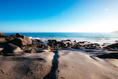 Scenic view of sea against clear blue sky