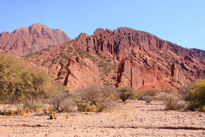 Scenic view of rocky mountains against clear blue sky