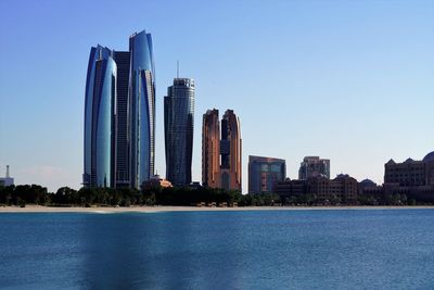 Modern buildings in city against clear sky