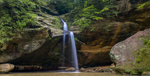 Scenic view of waterfall streaming in hocking hills state park