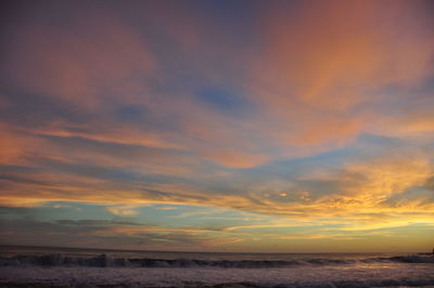 Scenic view of sea against romantic sky at sunset