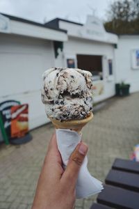 Cropped hand holding ice cream cone