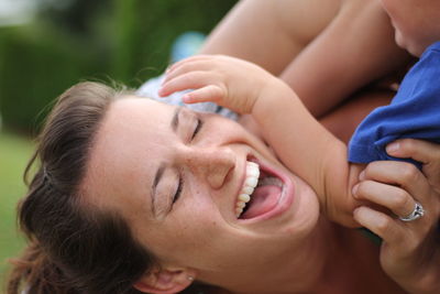 Close-up of happy mother playing with son