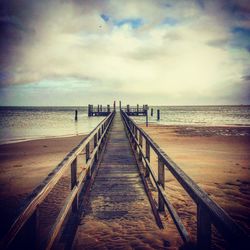 Pier over sea against sky
