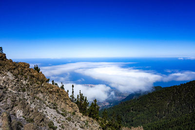 Scenic view of mountains against blue sky