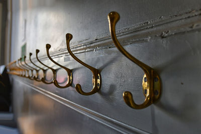 Close-up of hooks mounted on wall at home