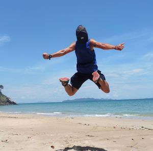 Full length of man jumping on beach
