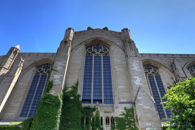 Low angle view of historic building against clear blue sky