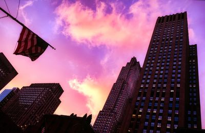 Low angle view of buildings against sky at sunset