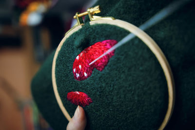 Close-up of woman holding red leaf