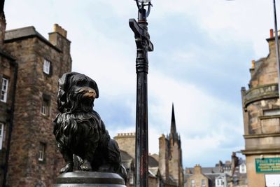 Statue of historic building against sky in city