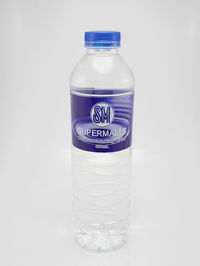 Close-up of glass bottle against white background