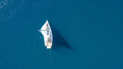 Sailboat sailing in sea against clear sky