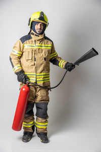 Portrait of man standing against white background