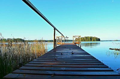 Pier leading to calm blue sea