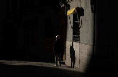 Adult man in suit on street in winter with sunlight and shadow