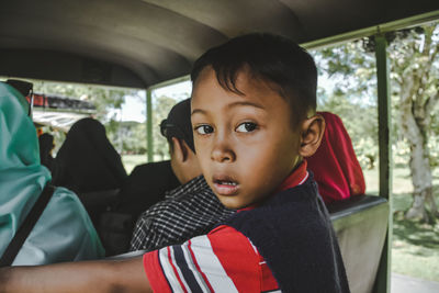 Portrait of boy sitting in vehicle