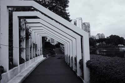 Footpath amidst buildings against sky