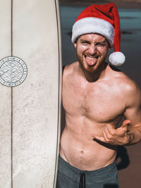 Portrait of shirtless man standing outdoors