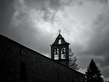 Low angle view of bell tower against sky