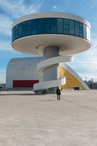 People in front of building against sky