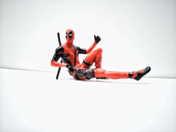 Full length of man lying on floor against white background