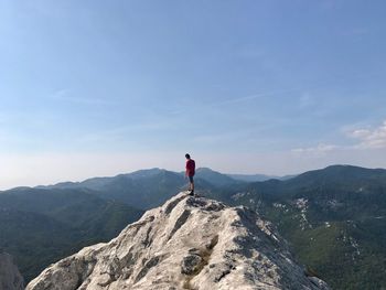 Full length of man standing on mountain against sky