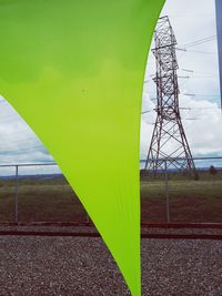 Electricity pylon on field against sky