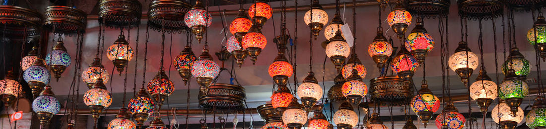 Low angle view of illuminated lanterns hanging outside building