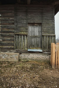 Old abandoned house against building