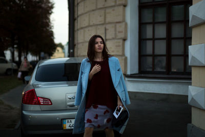 Portrait of young woman standing outdoors