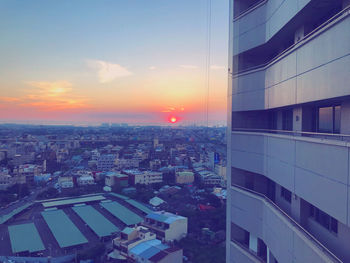 High angle view of buildings against sky during sunset