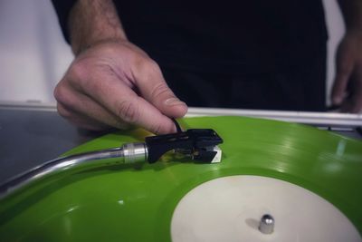 Midsection of man playing record