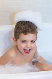 Portrait of smiling boy in bathroom