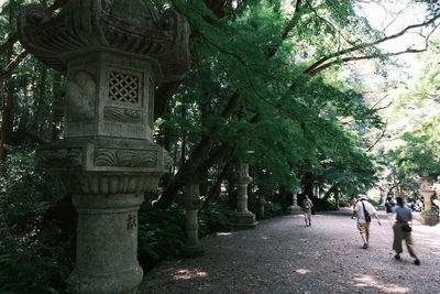 People walking in park by building