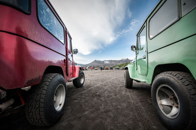 Off-road vehicles on road against sky