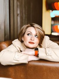 Portrait of young woman sitting on table