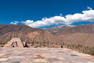 Scenic view of mountains against cloudy sky