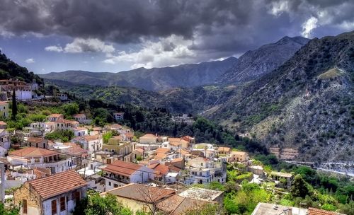 High angle view of houses and mountains against sky