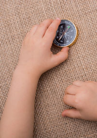 Close-up of hand holding navigational compass 