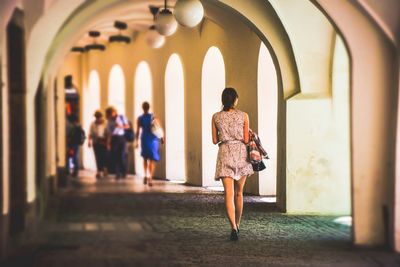 Woman walking through tunnel