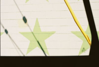 High angle view of yellow shadow on wall