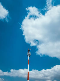 Low angle view of communications tower against blue sky