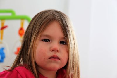 Close-up portrait of cute girl at home