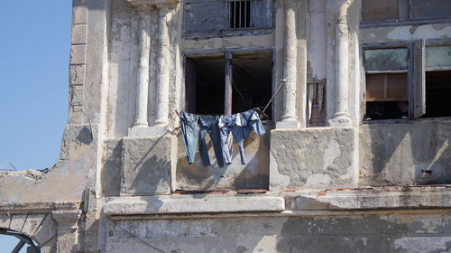 Low angle view of clothesline in old building balcony